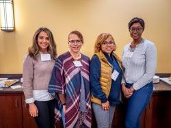 Women pose for a photo at WIN event